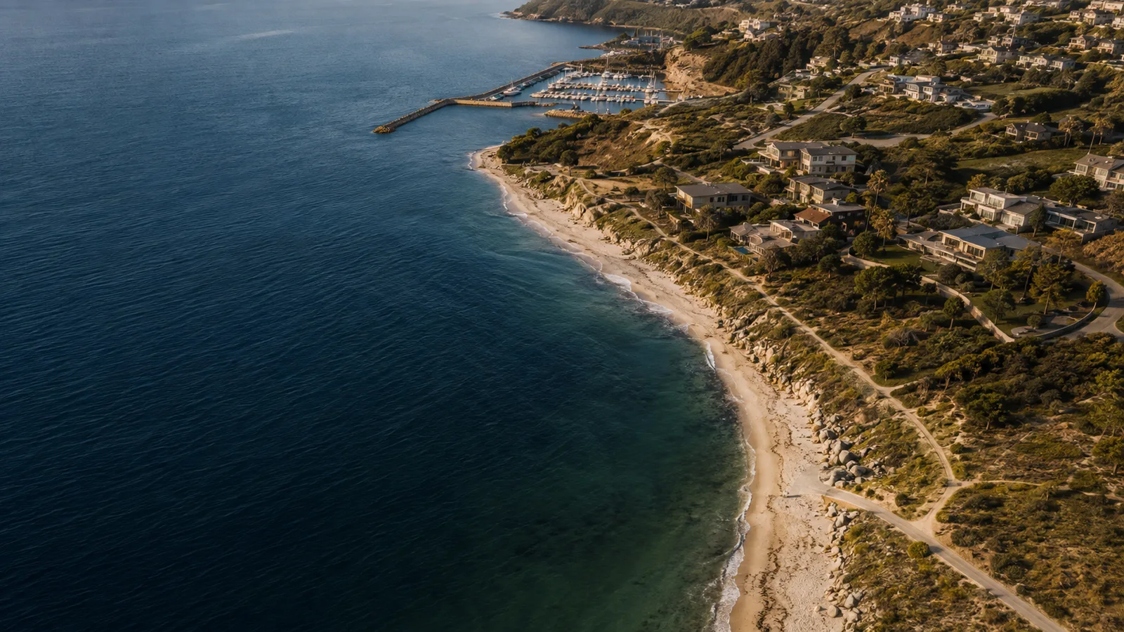 Concept aerial view of a coastline with deep blue water
